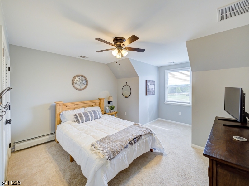 33 Kappus Road Milford, NJ 08848 - Photo 40 of 50 a bedroom with a bed and a chandelier