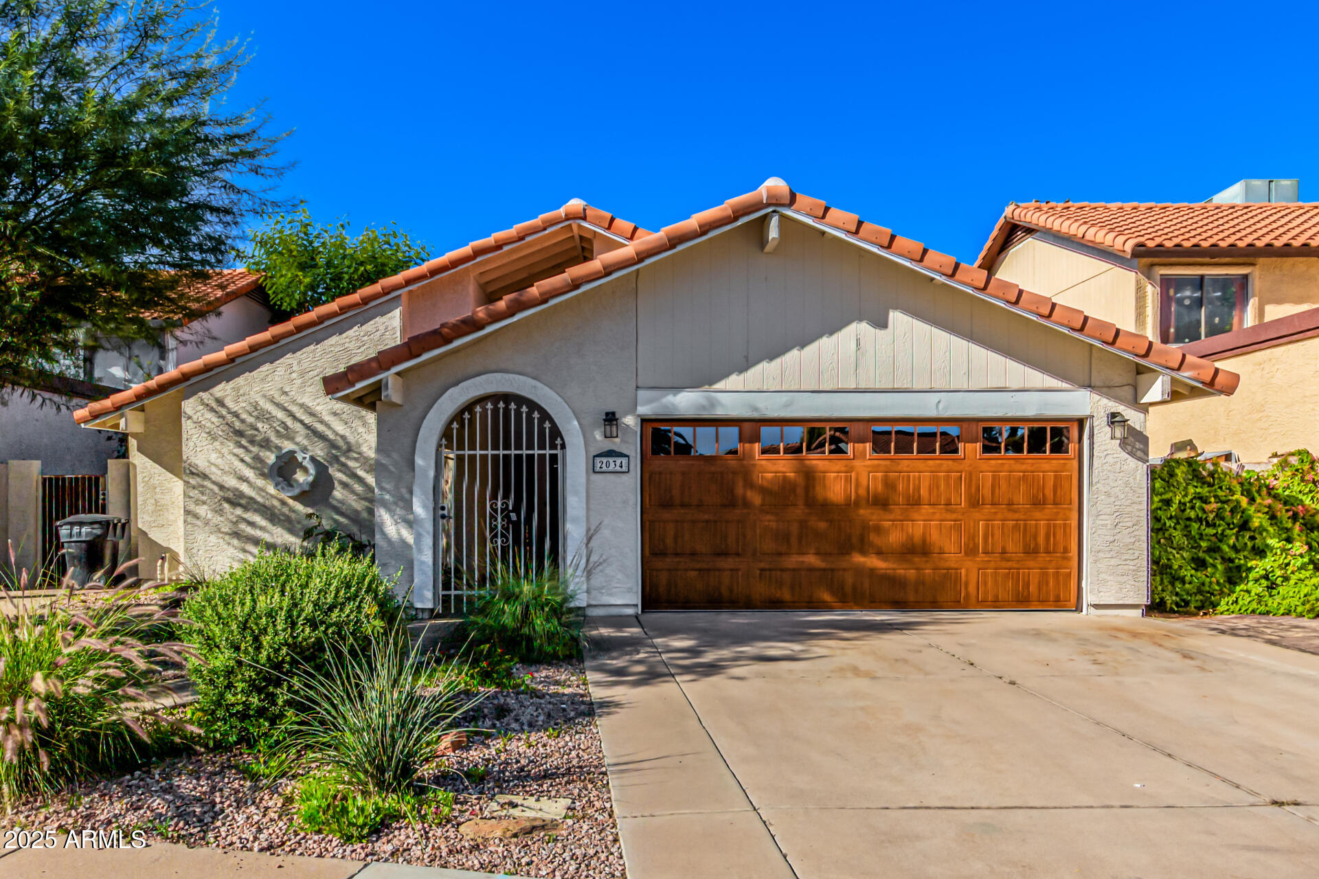 2034 South Paseo Loma Mesa, AZ 85202 - Photo 1 of 27 a front view of a house with a yard and garage