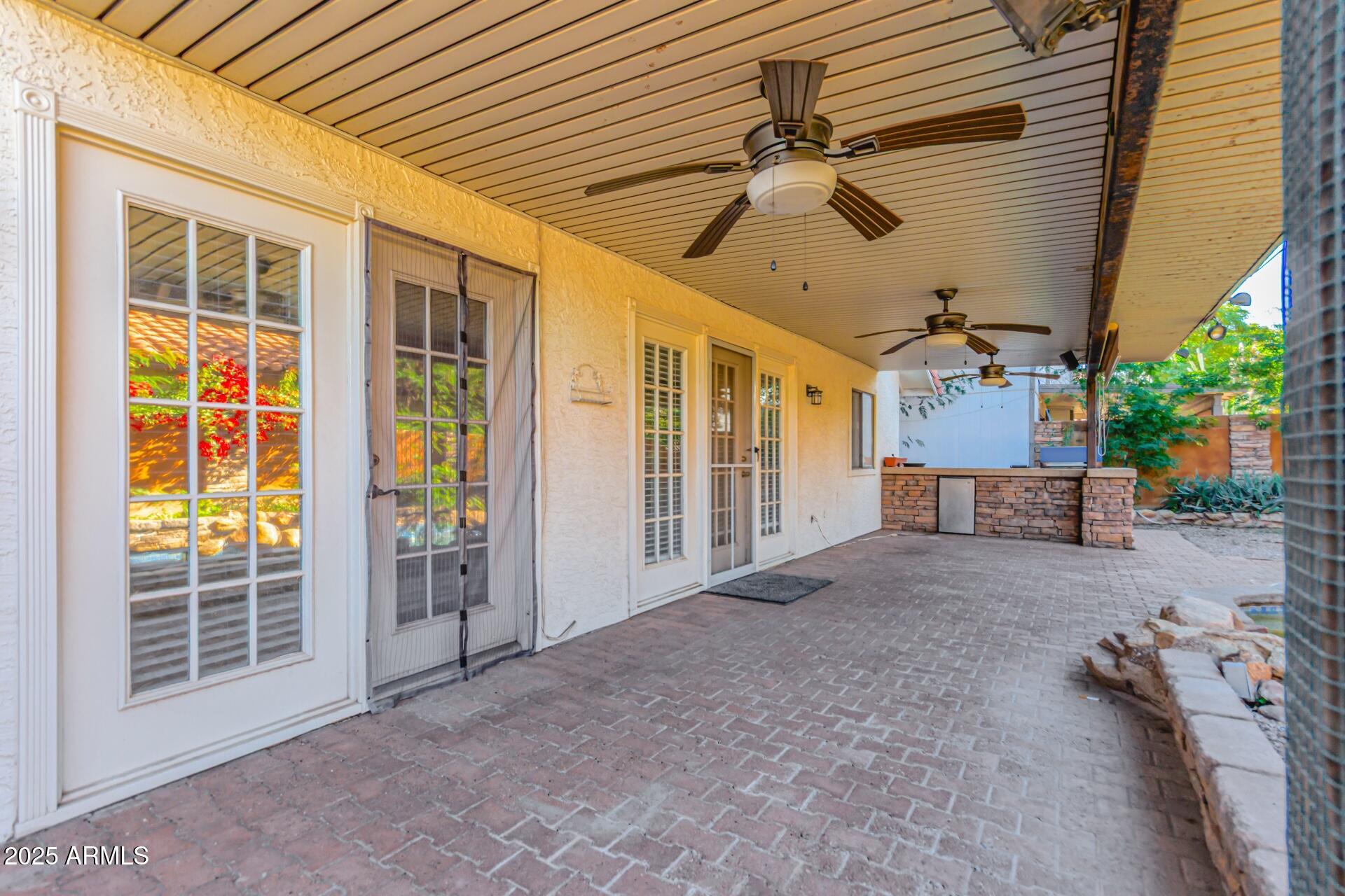 2034 South Paseo Loma Mesa, AZ 85202 - Photo 24 of 27 a view of a porch with furniture and floor to ceiling window