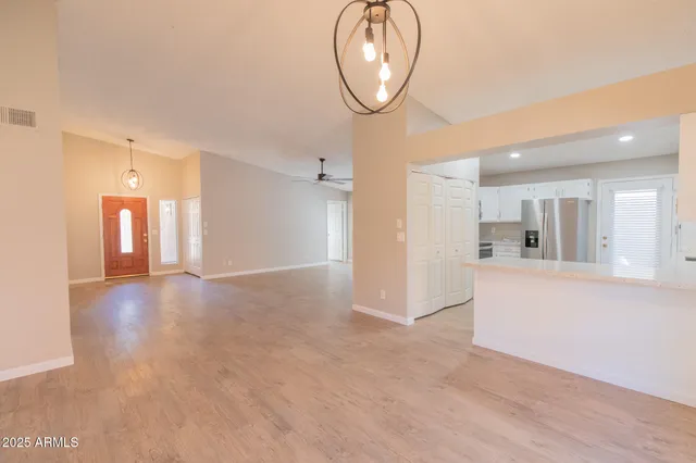 a kitchen with refrigerator and cabinets