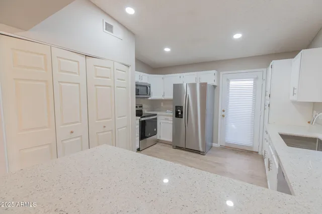 a kitchen with white cabinets