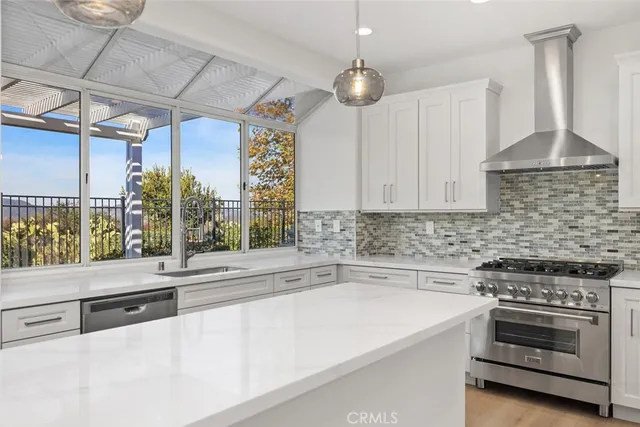 a kitchen with a stove and a white cabinets