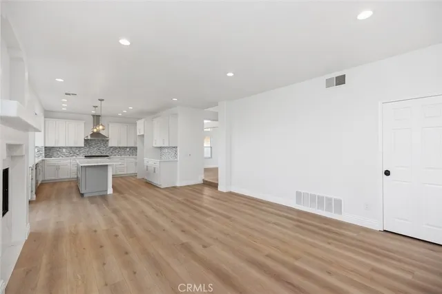a view of kitchen with kitchen island and stainless steel appliances