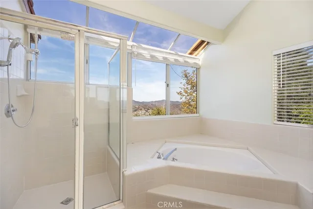 a bathroom with a bathtub and a shower