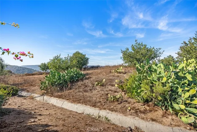 a view of a porch with furniture and garden