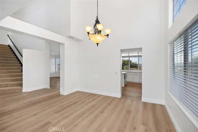 a view of a room with wooden floor closet and windows
