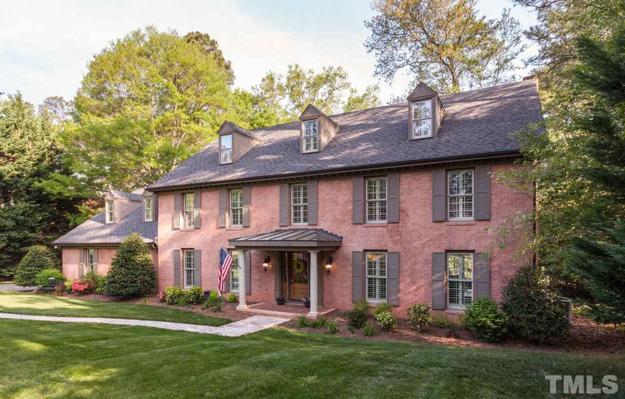 a front view of a house with a garden and plants