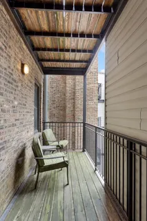 a balcony with furniture and wooden floor