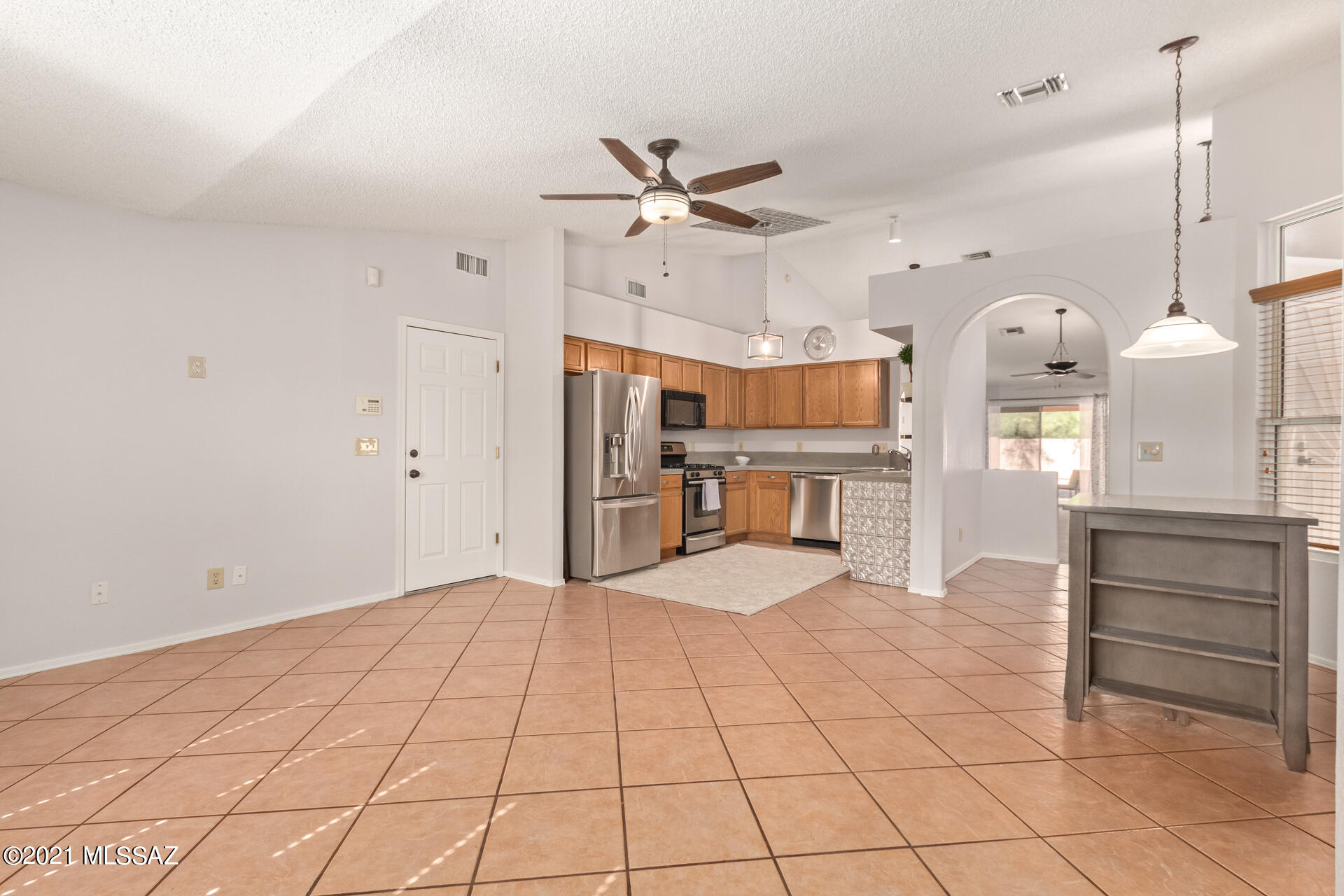 3034 West Sky Ranch Trail Tucson, AZ 85742 - Photo 8 of 27 a view of a kitchen with furniture and a ceiling fan