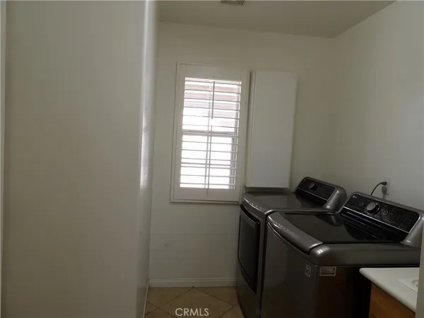 a close view of a sink and dishwasher with wooden floor