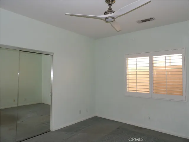 a view of hallway with a couch and a bathroom in it