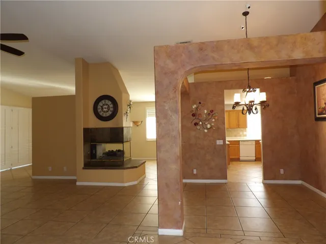 a view of a hallway with wooden floor and a living room