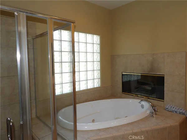 a bathroom with a tub and a window
