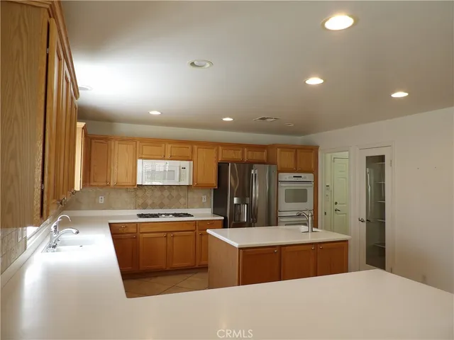 a kitchen with stainless steel appliances granite countertop a sink and stove