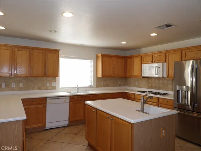 a kitchen with a sink stove and refrigerator