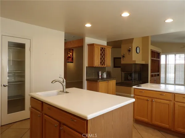 a large kitchen with kitchen island a sink stainless steel appliances and cabinets