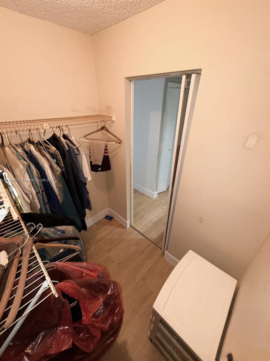 440 Lakeview Drive, Unit 102 Weston, FL 33326 - Photo 11 of 19 a view of walk in closet with clothes and shoes