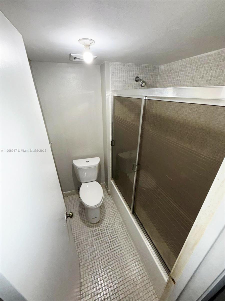 440 Lakeview Drive, Unit 102 Weston, FL 33326 - Photo 12 of 19 a bathroom with a toilet and a shower