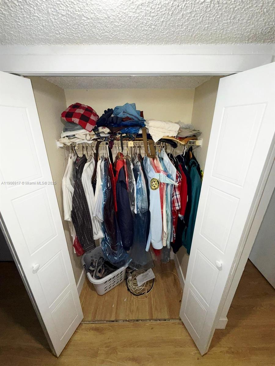 440 Lakeview Drive, Unit 102 Weston, FL 33326 - Photo 16 of 19 a view of walk in closet with clothes and shoes