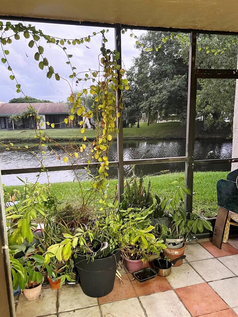 440 Lakeview Drive, Unit 102 Weston, FL 33326 - Photo 19 of 19 a view of a garden with a chair