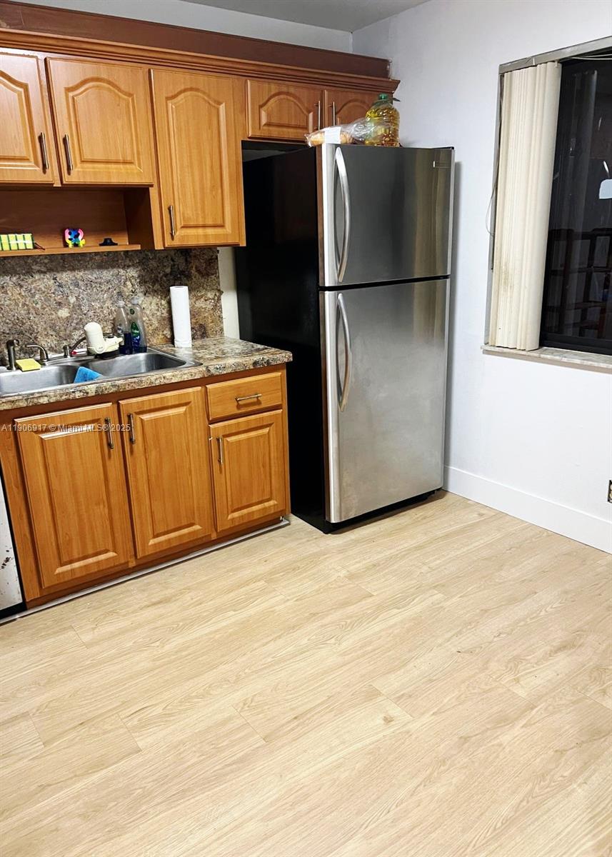 440 Lakeview Drive, Unit 102 Weston, FL 33326 - Photo 4 of 19 a kitchen with stainless steel appliances granite countertop a refrigerator a sink and dishwasher