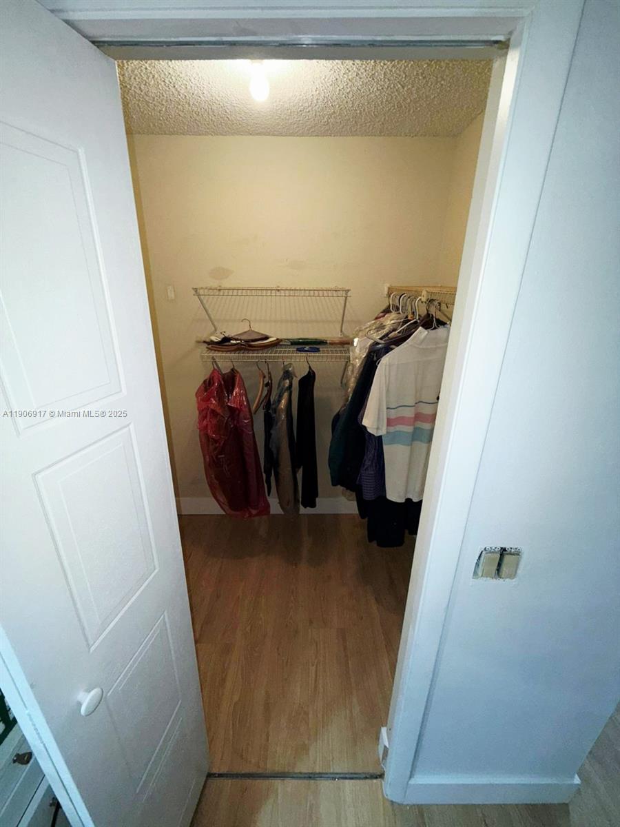 440 Lakeview Drive, Unit 102 Weston, FL 33326 - Photo 9 of 19 a view of walk in closet with clothes and shoes