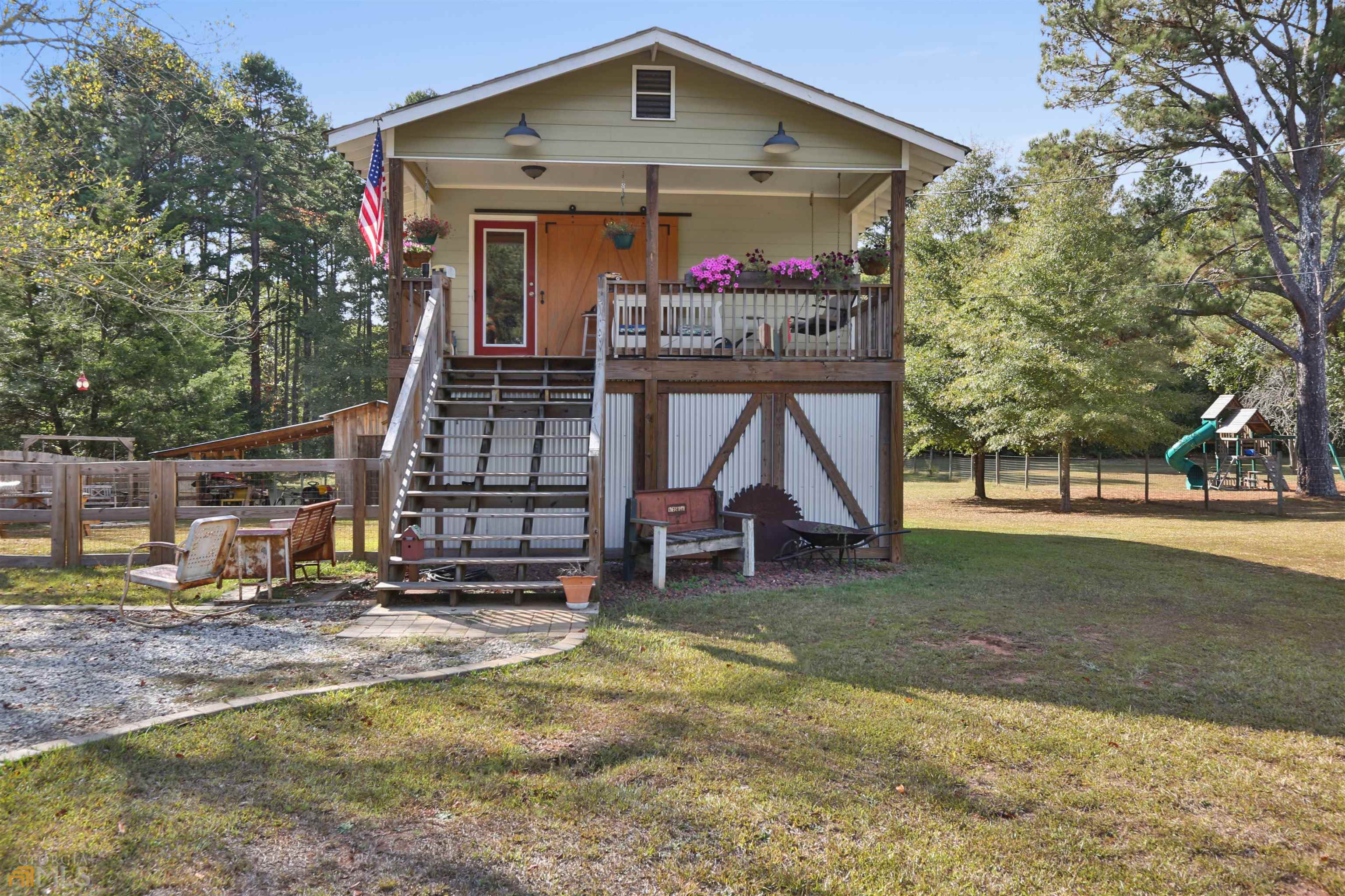 8510 Chastain Road Palmetto, GA 30268 - Photo 1 of 1 a view of a house with a small yard and a large tree