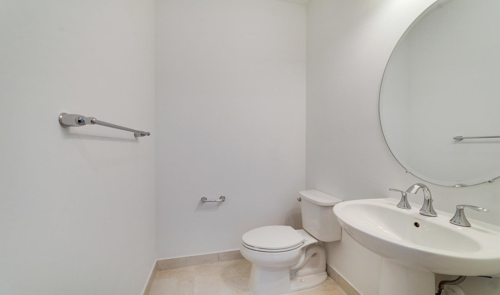 9952 Brickhill Drive Boca Raton, FL 33428 - Photo 5 of 24 a bathroom with a sink a toilet and mirror