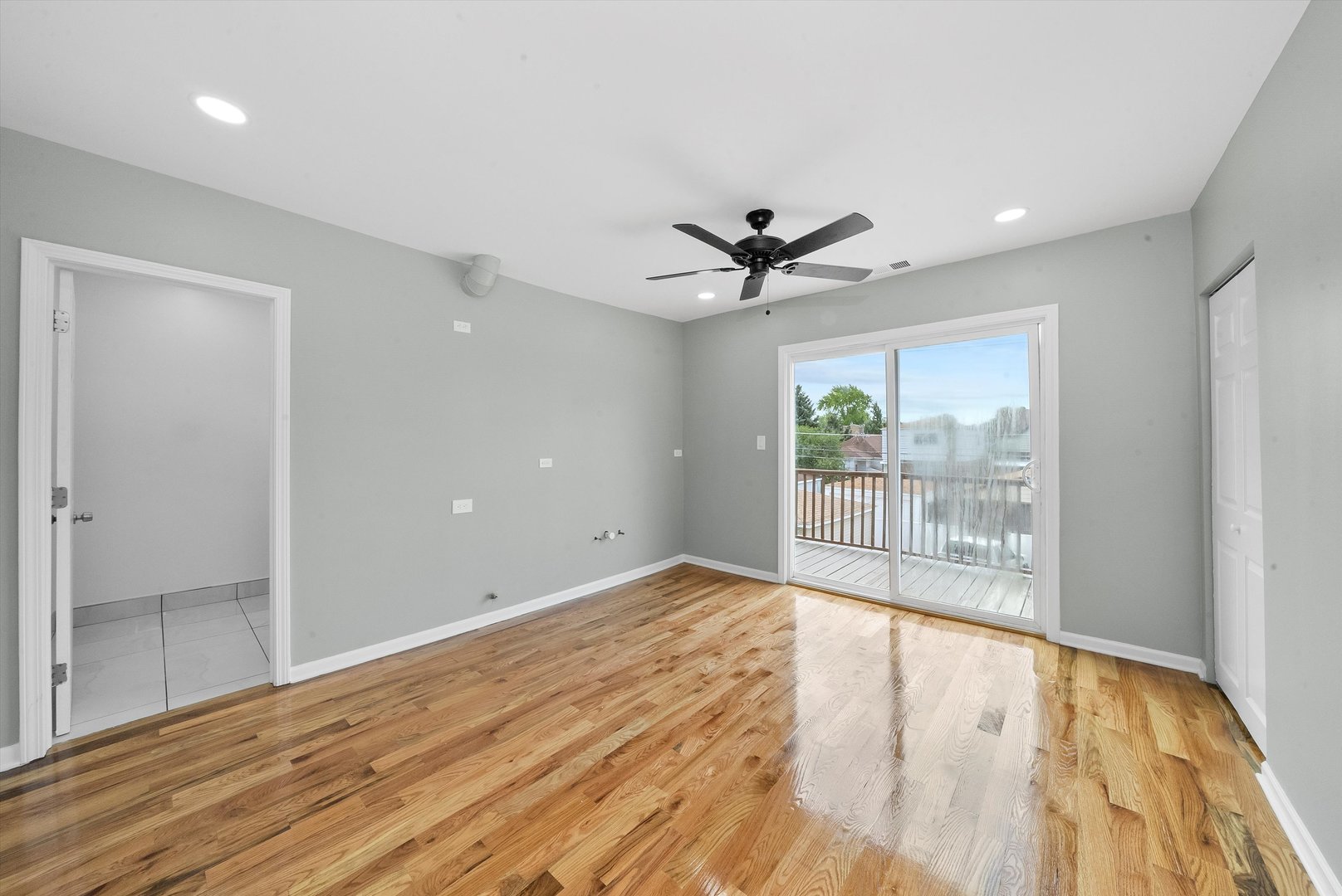 3343 West 59th Place, Unit 2 Chicago, IL 60629 - Photo 4 of 10 wooden floor in an empty room with a window
