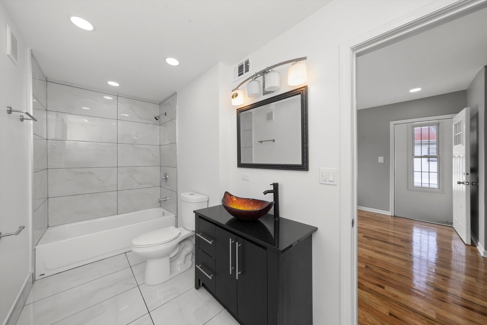 3343 West 59th Place, Unit 2 Chicago, IL 60629 - Photo 5 of 10 a bathroom with a sink toilet and shower