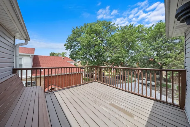 a balcony with wooden floor and city view