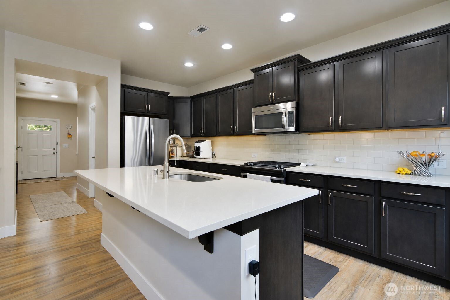 19607 25th Drive Southeast Bothell, WA 98012 - Photo 4 of 30 a kitchen with kitchen island wooden cabinets a sink and a refrigerator