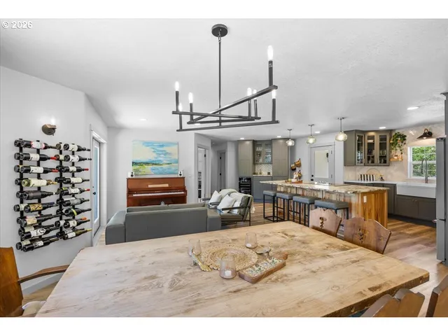 a living room with furniture a dining table and chairs with the view of kitchen