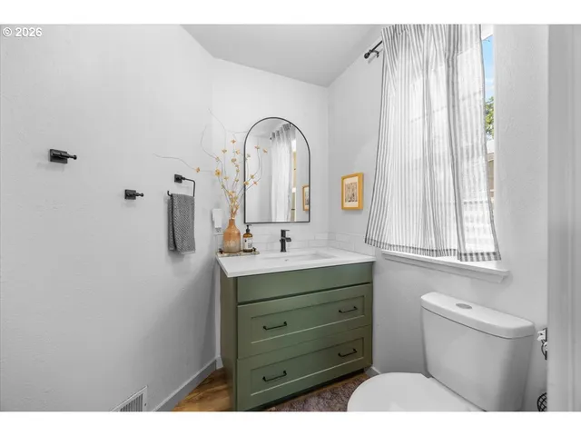 a bathroom with a toilet sink and mirror