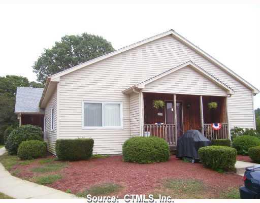 a view of a house with a yard and plants