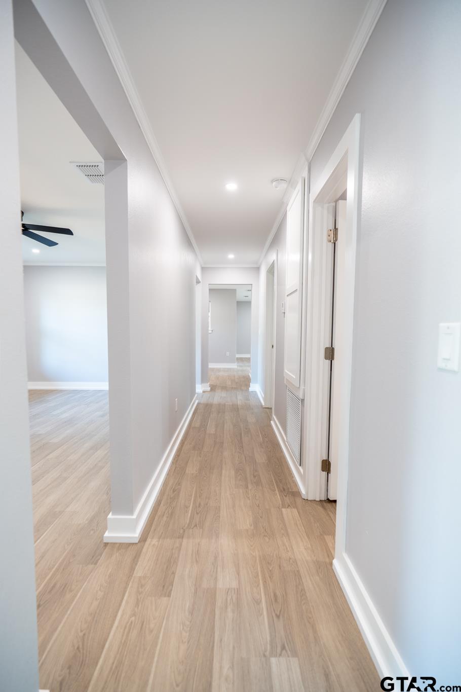 2922 West Azalea Drive Tyler, TX 75701 - Photo 19 of 39 a view of a hallway with wooden floor