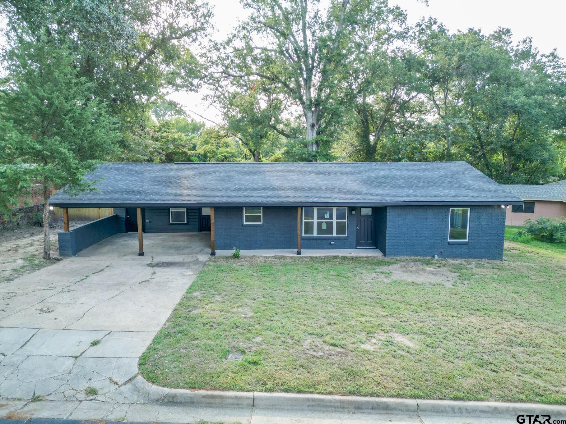 2922 West Azalea Drive Tyler, TX 75701 - Photo 35 of 39 a backyard of a house with table and chairs