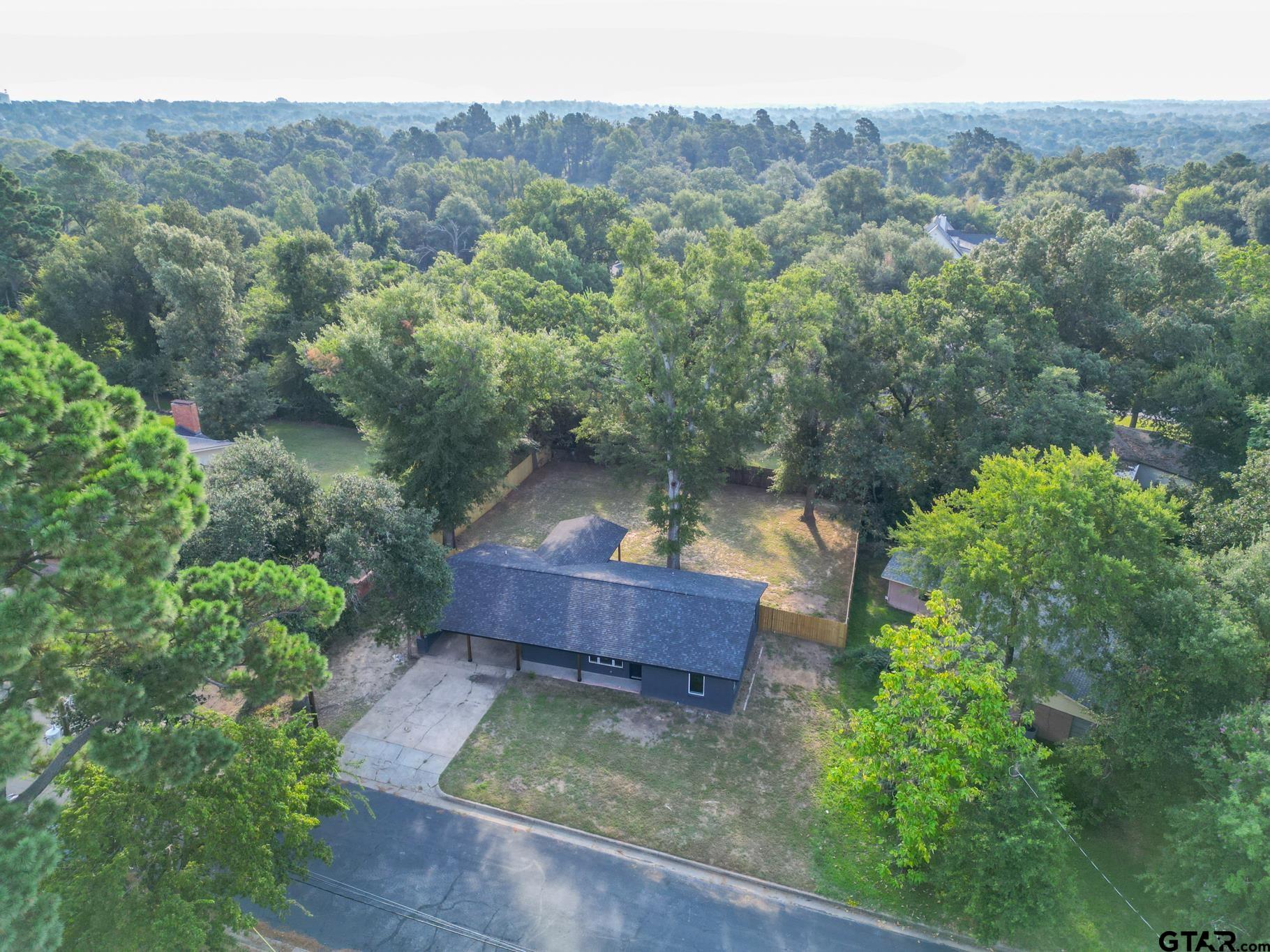 2922 West Azalea Drive Tyler, TX 75701 - Photo 37 of 39 an aerial view of a house with a yard