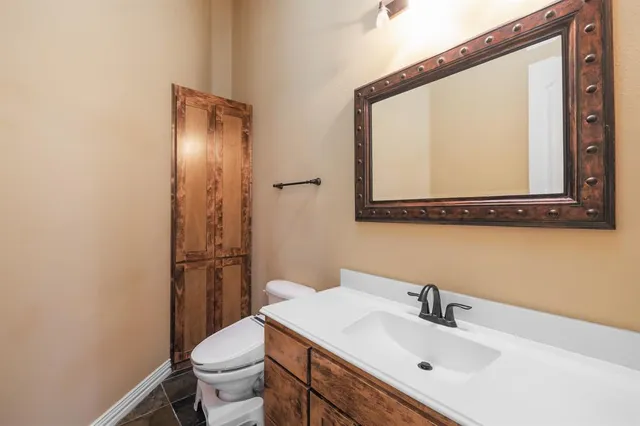 a bathroom with a sink toilet and mirror