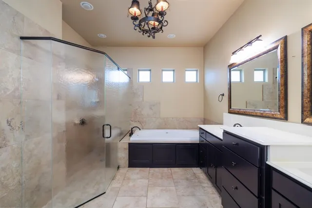 a bathroom with a bathtub a sink and a mirror