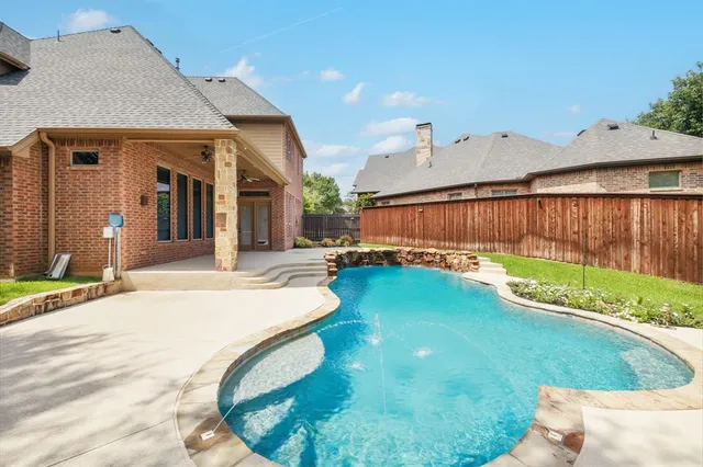 a swimming pool with yard in front of it