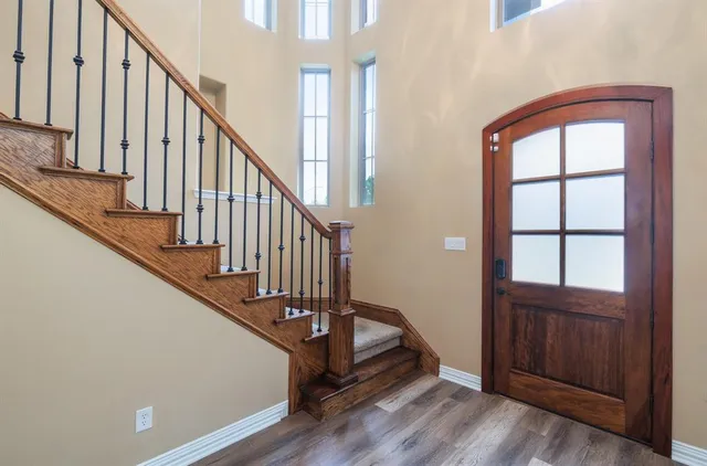 a view of an entryway with wooden floor and door