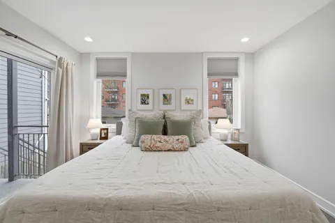 a bedroom with a large bed and a window