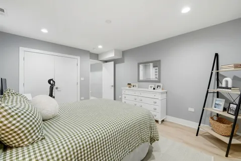 a bedroom with a bed and a chair