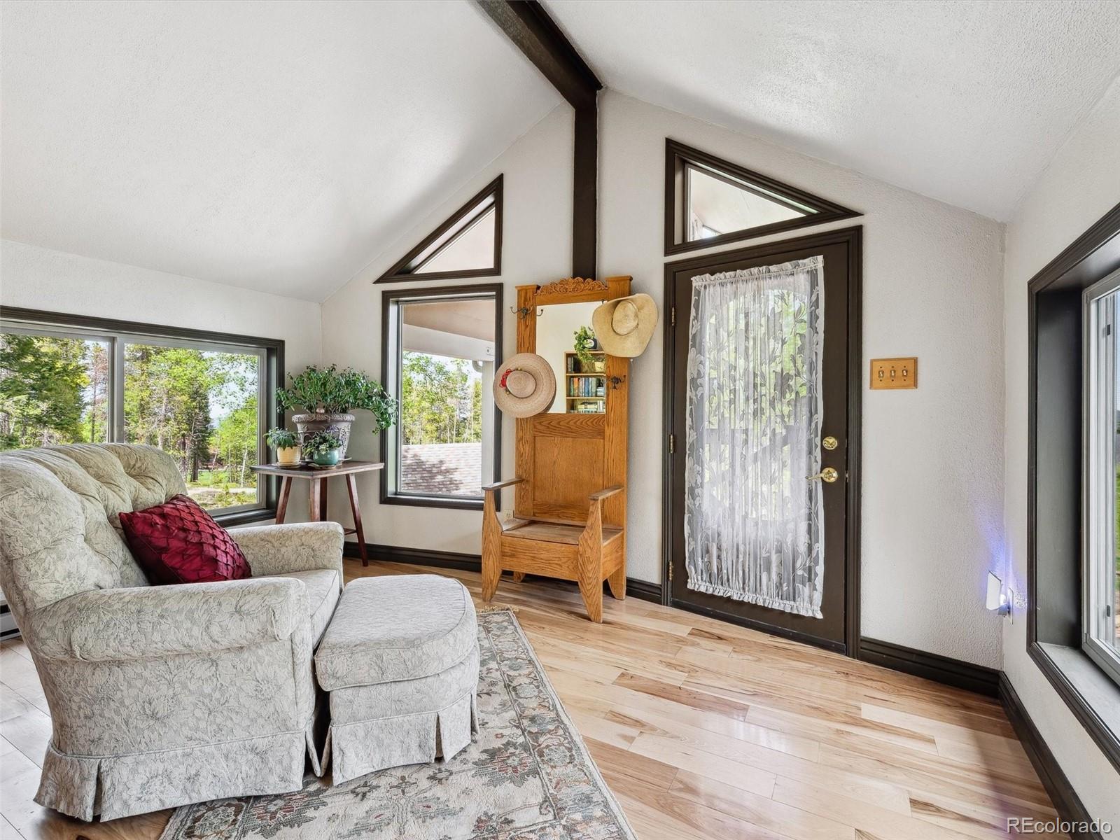 9390 South Warhawk Road Conifer, CO 80433 - Photo 12 of 46 a living room with furniture and a window