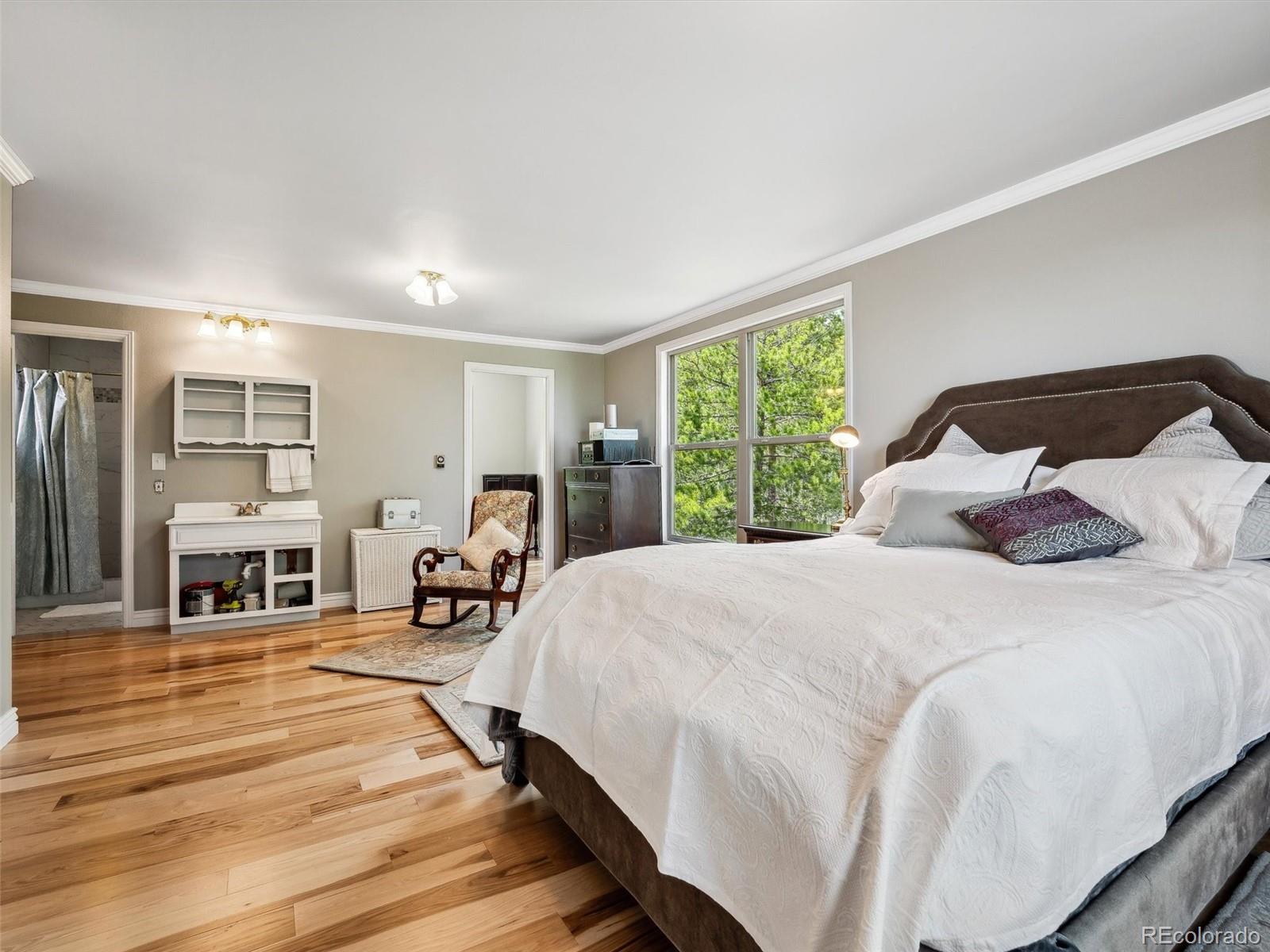 9390 South Warhawk Road Conifer, CO 80433 - Photo 25 of 46 a bedroom with bed and a large window