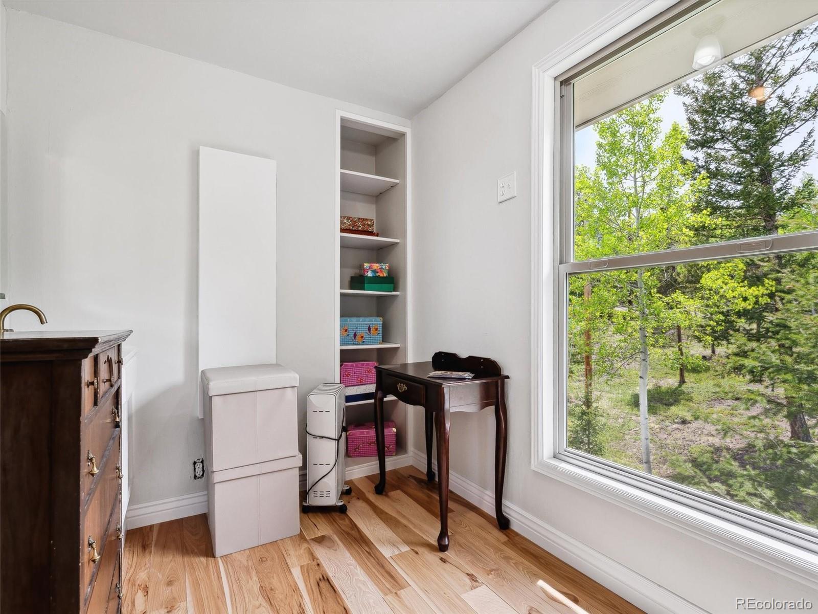 9390 South Warhawk Road Conifer, CO 80433 - Photo 28 of 46 a living room with furniture and a window