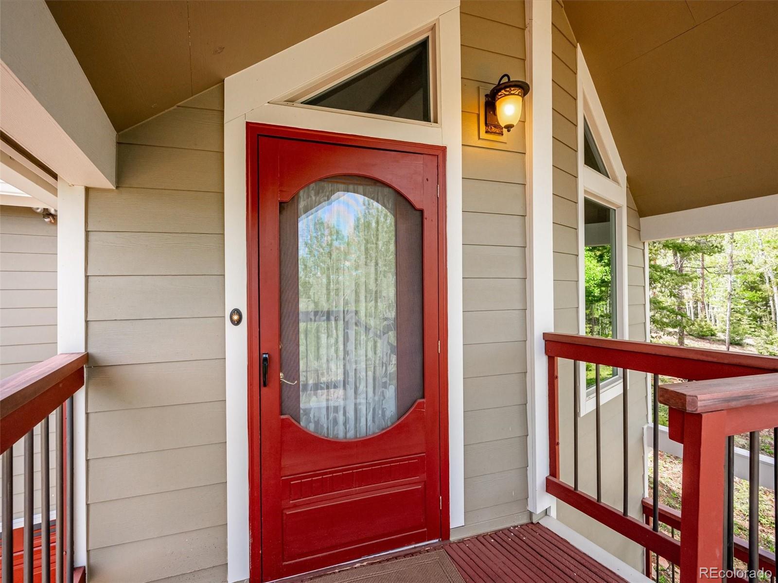 9390 South Warhawk Road Conifer, CO 80433 - Photo 45 of 46 a view of front door of a house