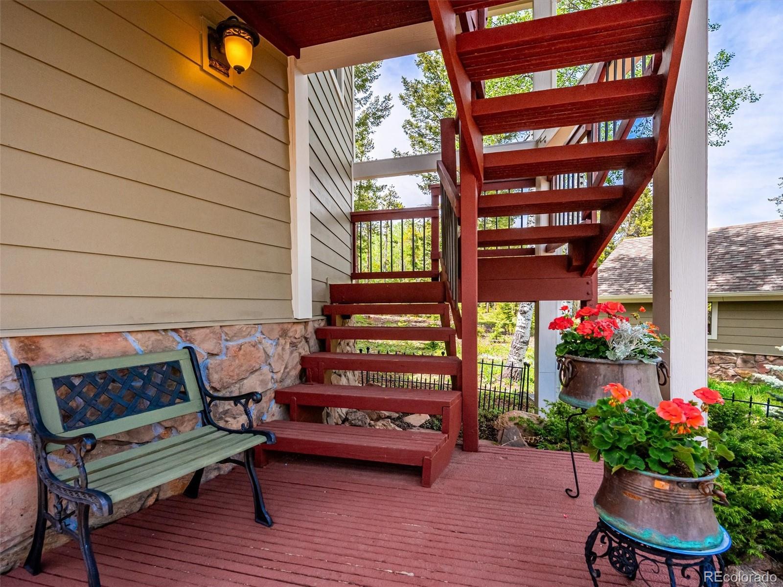 9390 South Warhawk Road Conifer, CO 80433 - Photo 46 of 46 a outdoor living space with patio furniture and flowers