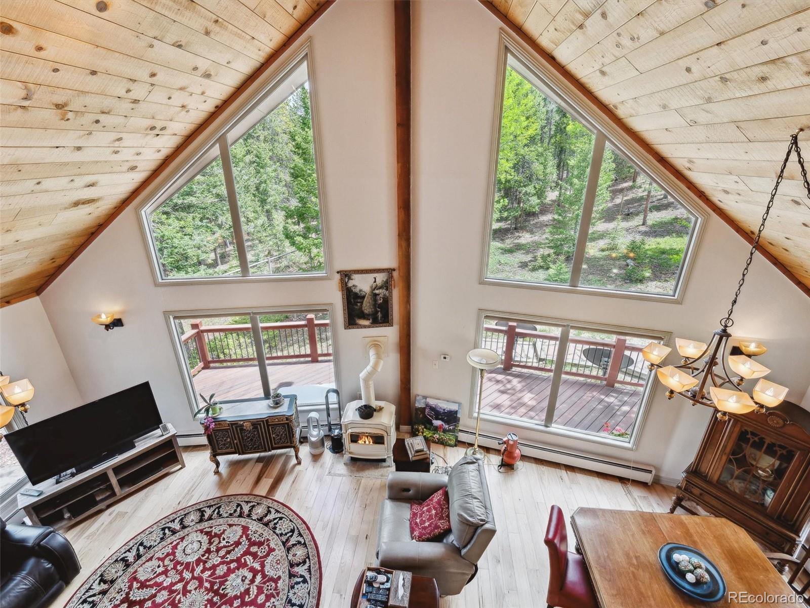 9390 South Warhawk Road Conifer, CO 80433 - Photo 7 of 46 a living room with furniture and a window